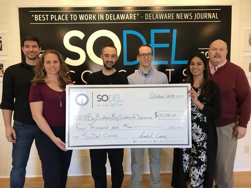 Check presentation attendees shown are (l-r) Drew Synnestvedt, manager of Bluecoast Seafood Grill + Raw Bar in Rehoboth Beach; Lindsey Barry, president of SoDel Cares; Chris Parks, executive chef of Lupo Italian Kitchen in Rehoboth Beach; Chris Carmean, general manager of Lupo Italian Kitchen; Stephanie Johnnie, director of development, and Brad Spicer, local program director, both with Big Brothers Big Sisters of Delaware.